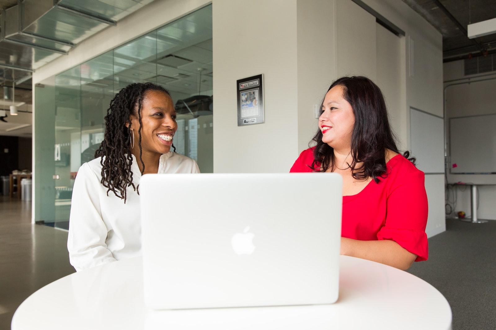 Two Women in Front of Silver Macbook