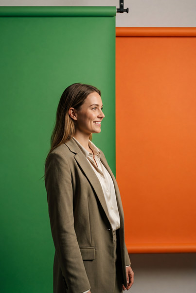 A woman with red wavy hair wearing a striped shirt.